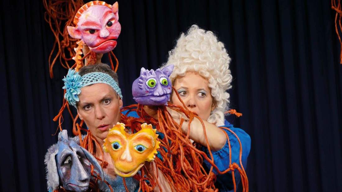 Puppenschauspielerinnen stehen auf der Bühne