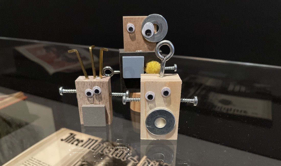 Selbstgebaute kleine Roboter schauen aus dem Bild.